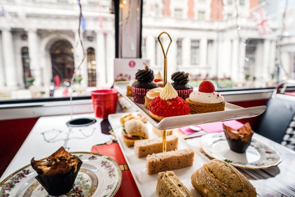 Delightful afternoon tea setup with pastries and sandwiches in a London cafe.